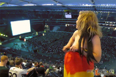 Nude blonde with German flag flashing nude in sports arena Public Flashing