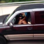 Mature African whore handjob in a car
